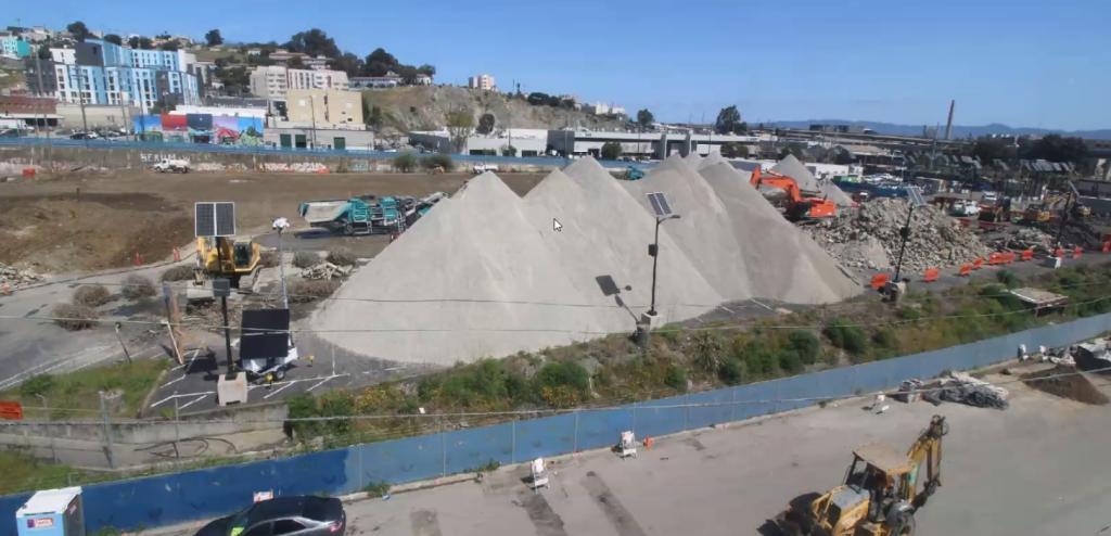 photo of site showing large piles of aggregate 