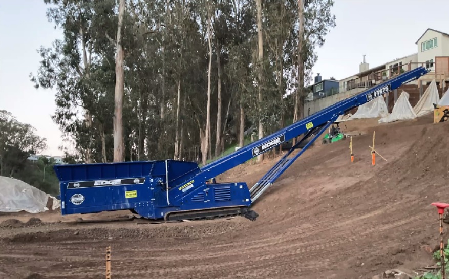 Machine adding material to base of new slope