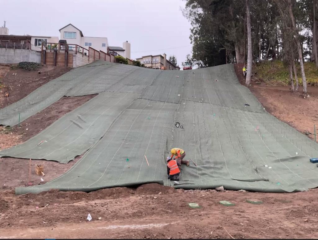 Photo of matting material being laid down on the slope