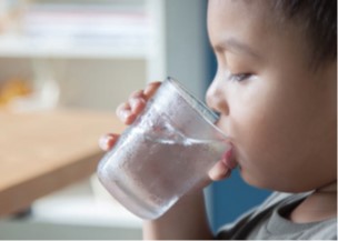 photo of child drinking glass of water