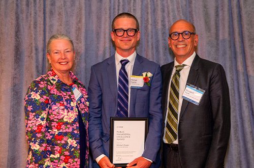 Mike Hyams receives the award with Barbara Hale and Ron Flynn.