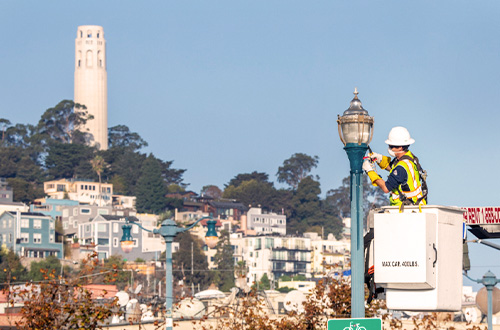 SFPUC Power Crew changing a lightbulb.