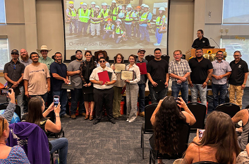Having just received their certificates of program completion (in Multi-Craft Core curriculum, OSHA 10, and more), graduates of Cohort 15 pose for a photo opp.