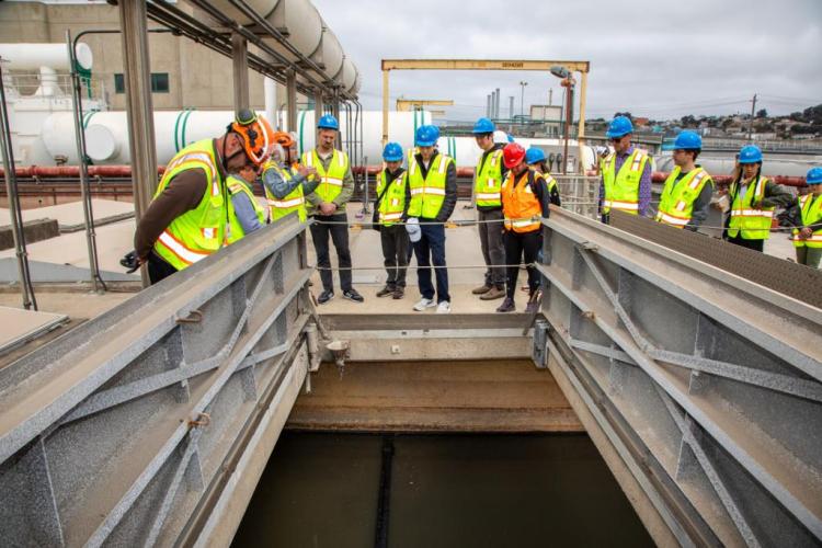 Group of attendees at the Southeast Treatment Plant tour look into the infrastructure below