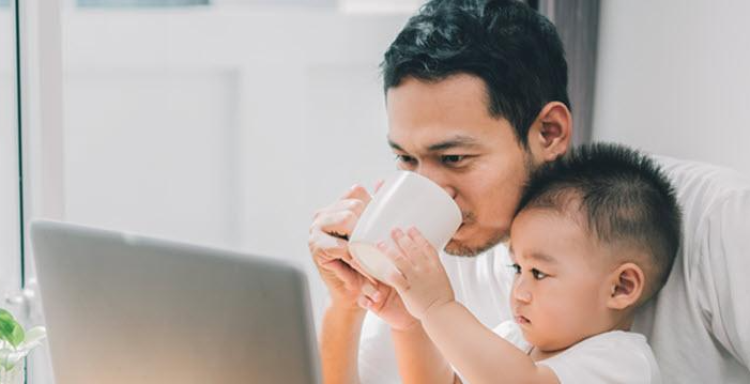 Father and son paying bill on computer