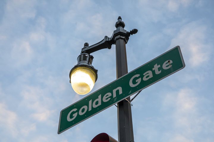 Light pole with a sign that reads Golden Gate affixed to it