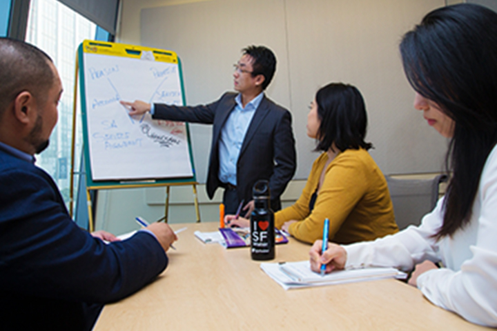 man pointing to a chart during his presentation