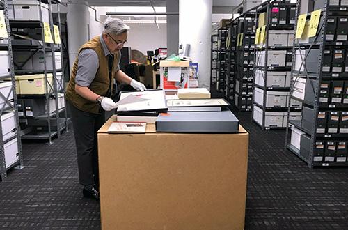 Museum collections registrar Ramón Silvestre working in the Dr. John P. De Cecco Archives and Special Collections of the GLBT Historical Society; photograph by Ellis Martin.