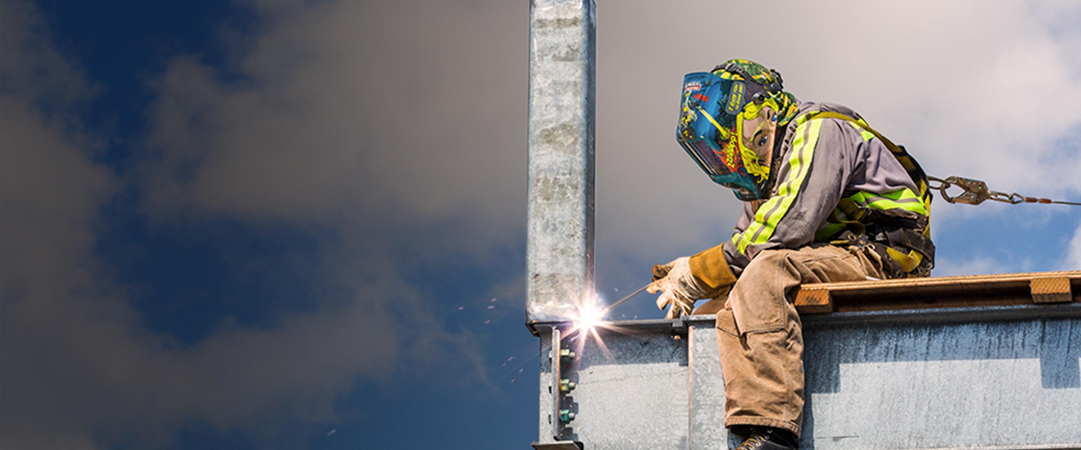Photo of construction worker welding sewer system infrastructure