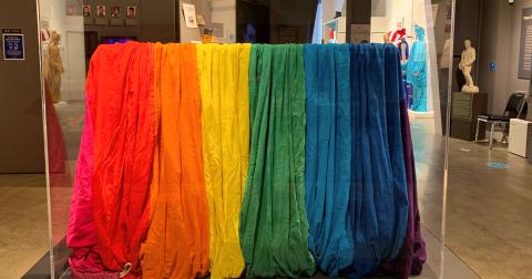 The segment of one of the original rainbow flags created for San Francisco Gay Freedom Day 1978 rests in its case at the GLBT Historical Society Museum; photograph by Andrew Shaffer.