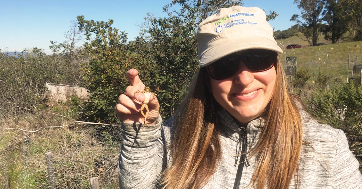 Mia Ingolia poses with a Pacific tree frog.
