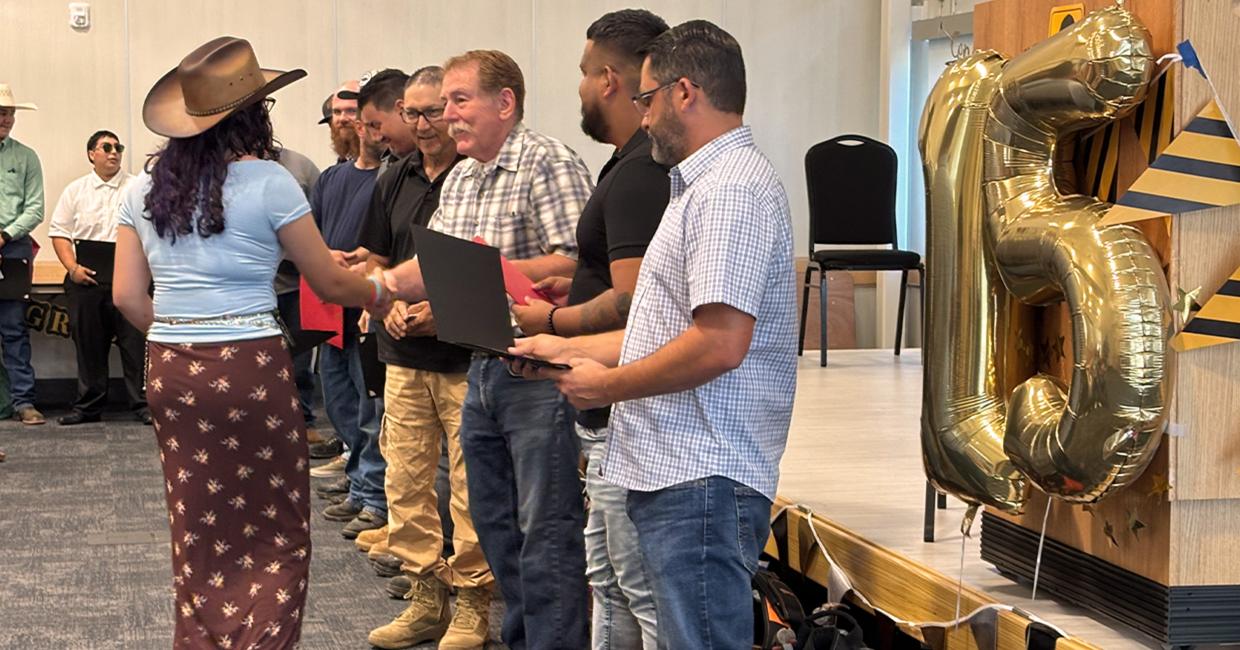 Graduates walk down the line to shake hands and receive all of their earned certificates such as OSHA 10, MC3, First Aid/CPR and more.