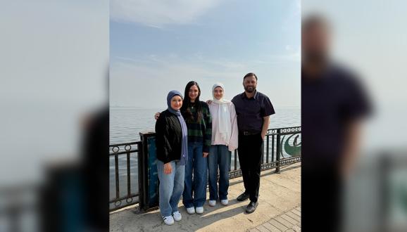 Azim posing for a family picture in San Francisco with his wife and two daughters. 