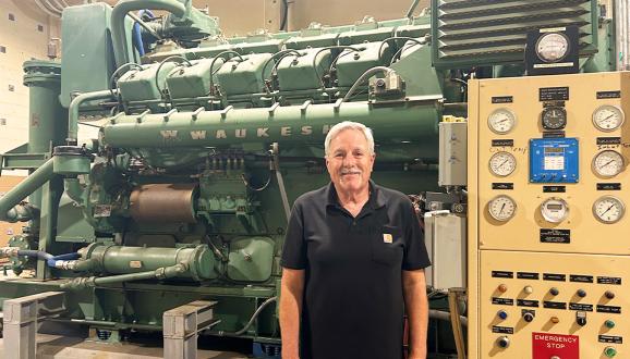 Frank Calvo in front of the diesel pump at the San Antonio Pump Station that saved the day.
