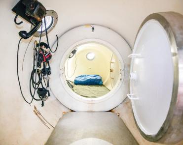 The decompression chamber within the diving barge helps the divers avoid decompression sickness as they reacclimate to the surface.